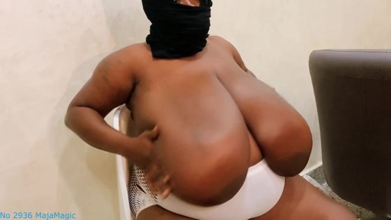 Angela plays with her huge ebony 44R Cup Breasts